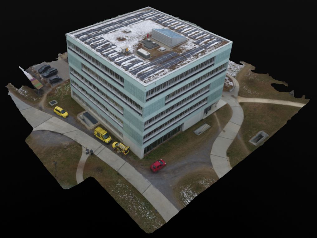 Textured 3D model of an office building and its surrounding grounds.